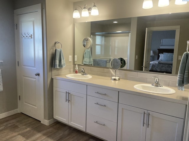230 Ladera St, Prosser, WA 99350 - ensuite bathroom featuring double vanity, a sink, connected bathroom, and wood finished floors