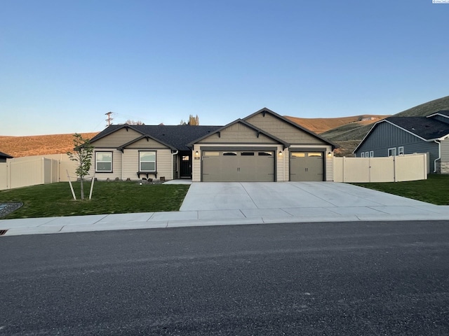 230 Ladera St, Prosser, WA 99350 - view of front facade with driveway, a front lawn, fence, and a garage