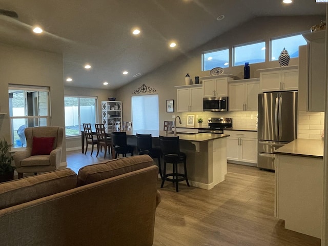 230 Ladera St, Prosser, WA 99350 - living area with high vaulted ceiling, recessed lighting, and wood finished floors