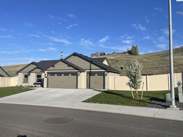 230 Ladera St, Prosser, WA 99350 - view of front facade with a front yard, fence, a garage, and concrete driveway