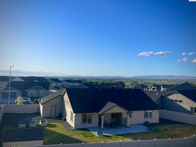 230 Ladera St, Prosser, WA 99350 - exterior space with a patio area, a fenced backyard, a front lawn, and a residential view