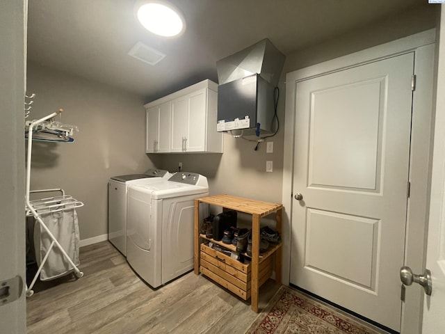 230 Ladera St, Prosser, WA 99350 - laundry room featuring light wood-style floors, washer and clothes dryer, and cabinet space