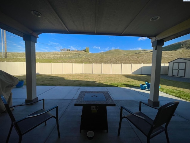 230 Ladera St, Prosser, WA 99350 - view of patio / terrace with a storage shed, an outbuilding, and a fenced backyard