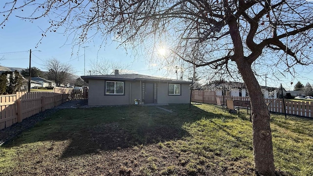 rear view of house with a lawn