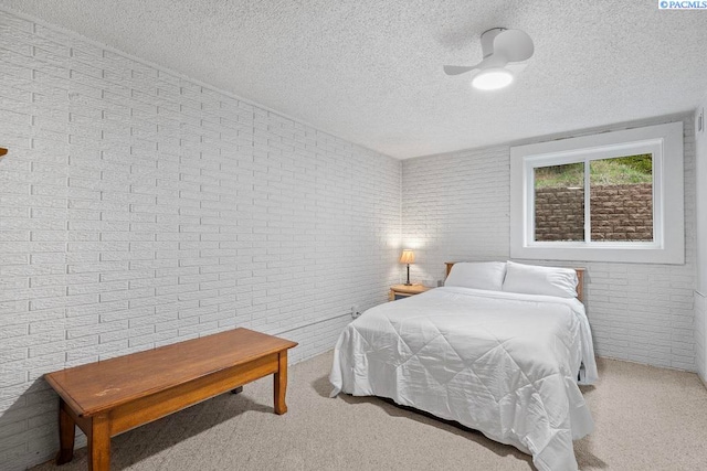 320 SW Kimball Dr, Pullman, WA 99163 - bedroom with brick wall, a textured ceiling, and carpet flooring