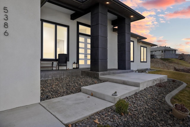 property entrance featuring stucco siding