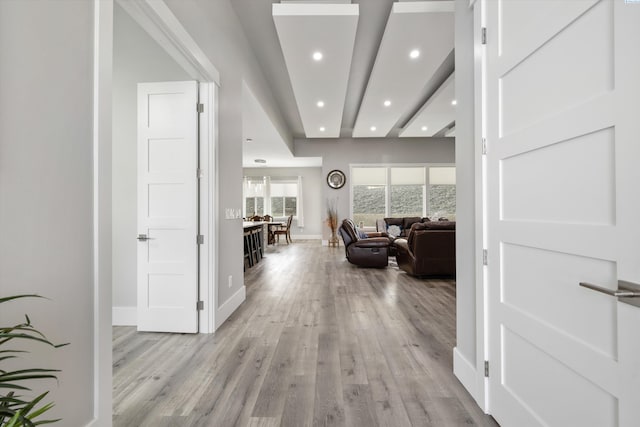 corridor featuring recessed lighting, light wood-style flooring, and baseboards