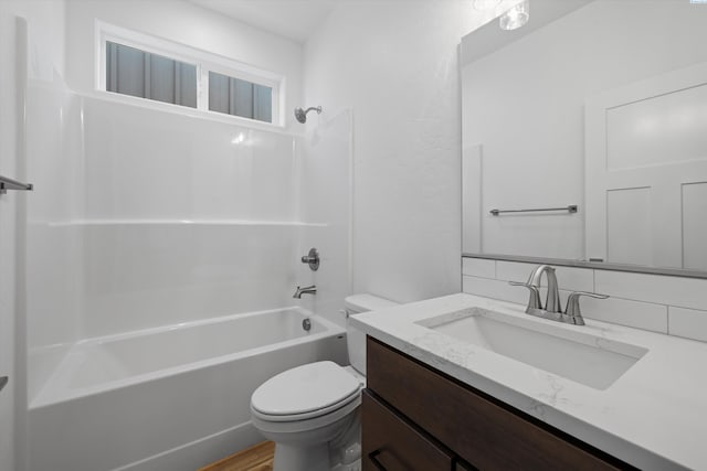 full bathroom featuring vanity, bathing tub / shower combination, and toilet