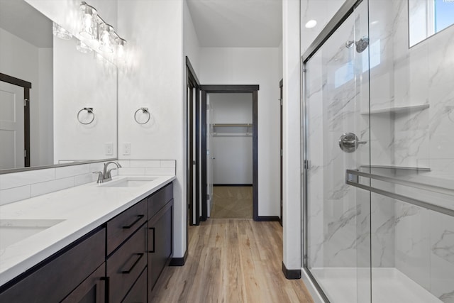 bathroom featuring vanity, an enclosed shower, and hardwood / wood-style floors