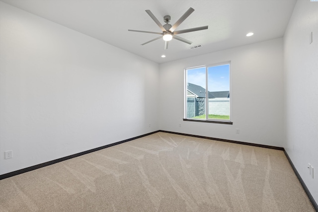 empty room featuring light carpet and ceiling fan