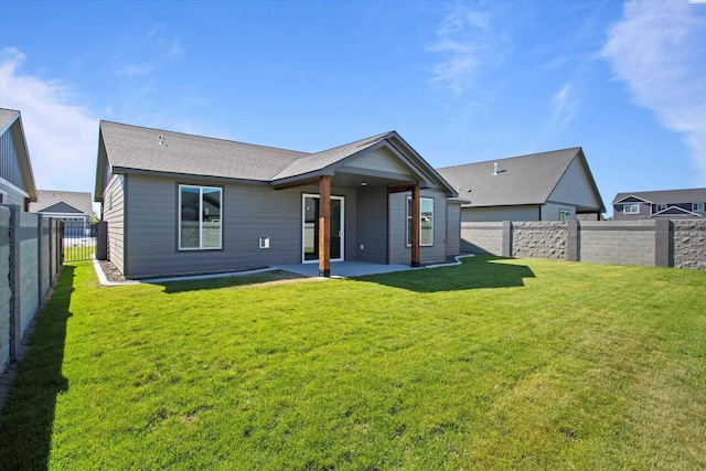 back of property featuring a yard and a patio