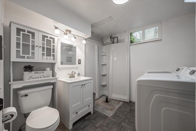 bathroom with walk in shower, toilet, parquet floors, vanity, and washing machine and dryer