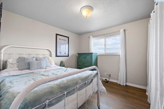 bedroom featuring wood-type flooring and a textured ceiling