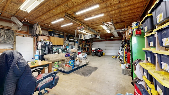 garage with a workshop area and black fridge with ice dispenser