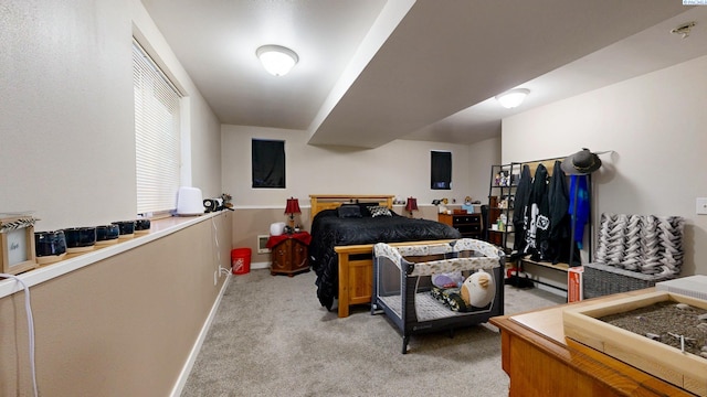 bedroom featuring light colored carpet and baseboards