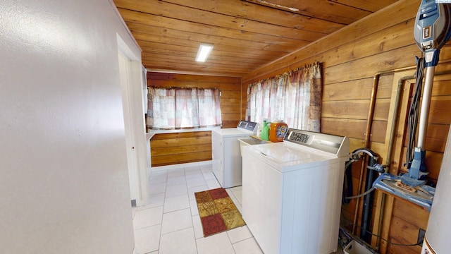 laundry area featuring laundry area, wooden ceiling, independent washer and dryer, wood walls, and light tile patterned flooring