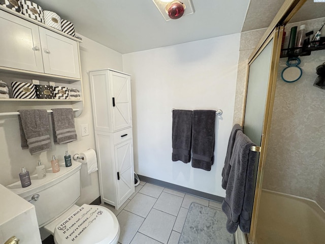 full bath with toilet, a stall shower, tile patterned flooring, and baseboards