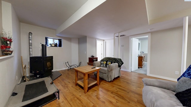 420 E Houghton St, Palouse, WA 99161 - living room featuring light wood finished floors, a wood stove, and baseboards
