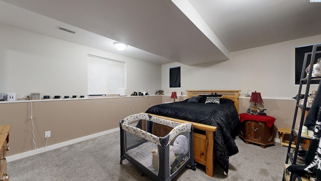 carpeted bedroom featuring visible vents and baseboards