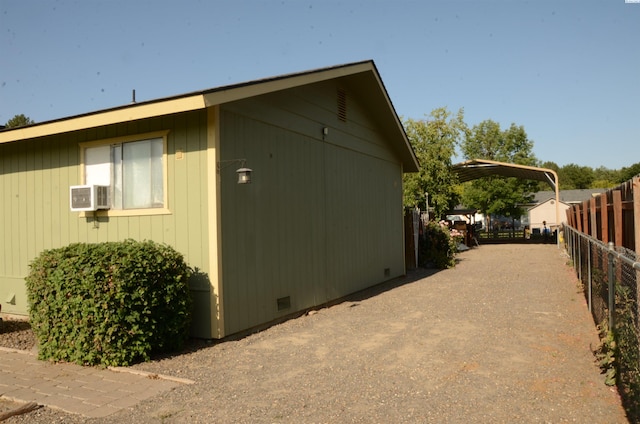 1026 Hemlock St, Prosser, WA 99350 - view of side of home with a detached carport, crawl space, and driveway