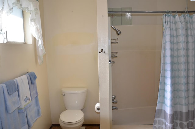 1026 Hemlock St, Prosser, WA 99350 - bathroom featuring toilet and shower / tub combo with curtain