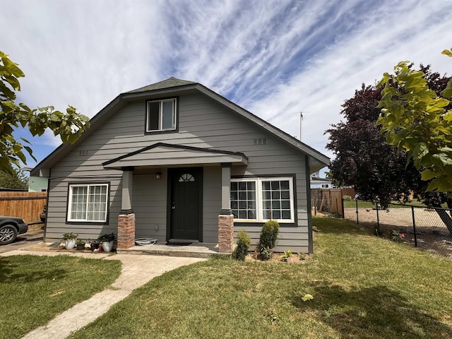 bungalow-style house with a front lawn