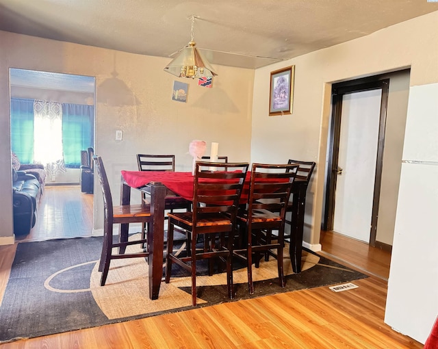 dining room with hardwood / wood-style floors