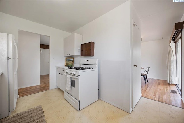 1923 Hood Ave, Richland, WA 99354 - kitchen with white appliances, light floors, light countertops, and white cabinetry