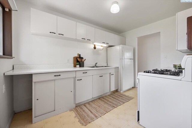 1923 Hood Ave, Richland, WA 99354 - kitchen with white appliances, light flooring, light countertops, and white cabinetry
