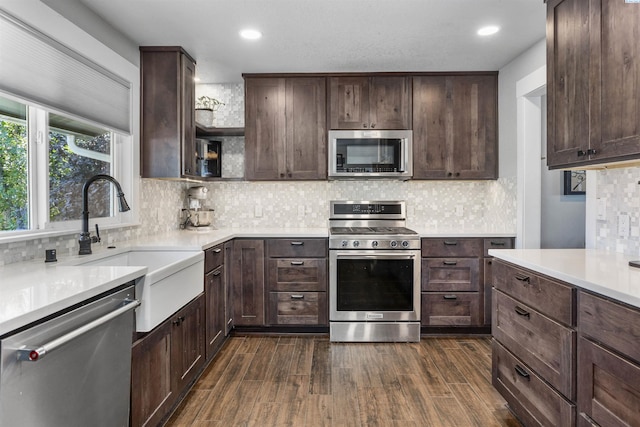 7816 W Argent Rd, Pasco, WA 99301 - kitchen with stainless steel appliances, dark brown cabinets, sink, and dark hardwood / wood-style floors