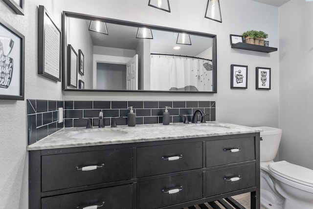 7816 W Argent Rd, Pasco, WA 99301 - bathroom with tasteful backsplash, vanity, and toilet