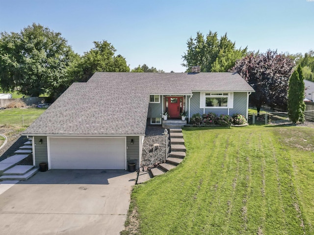 view of front of house featuring a garage and a front yard