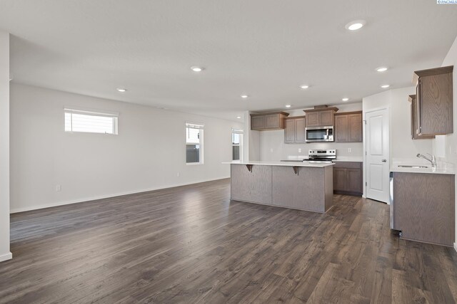 691 S Zeelar St, Kennewick, WA 99336 - kitchen with stainless steel appliances, open floor plan, a kitchen island, dark wood-style floors, and recessed lighting