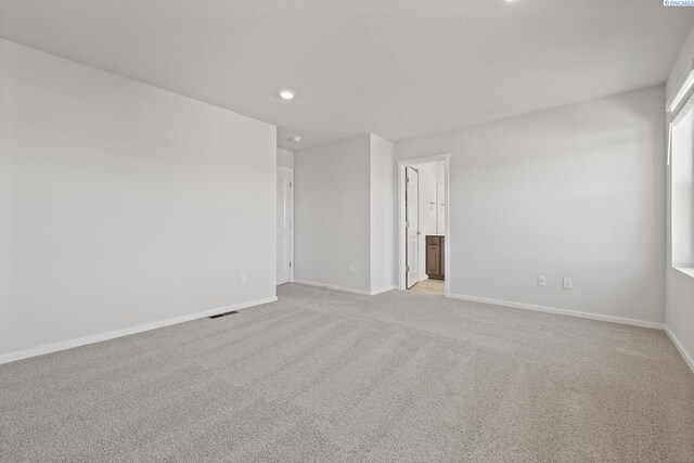 691 S Zeelar St, Kennewick, WA 99336 - empty room with baseboards, recessed lighting, and light colored carpet