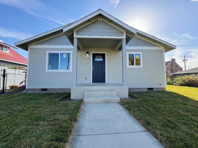 bungalow-style home featuring a front yard