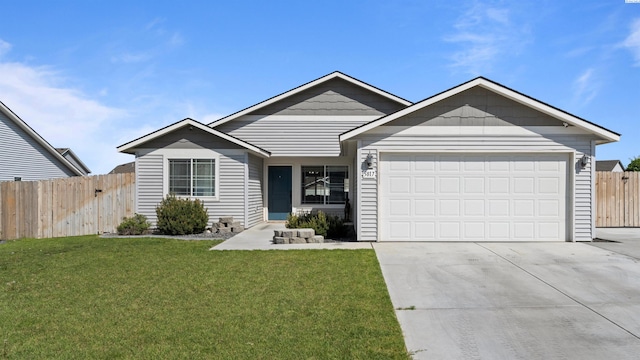 5817 Ramus Ln, Pasco, WA 99301 - ranch-style home featuring an attached garage, fence, driveway, and a front yard