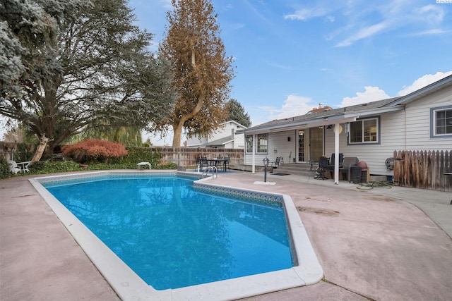 view of swimming pool with fence, a patio area, a fenced in pool, and entry steps