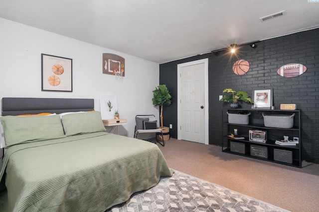 bedroom featuring visible vents, brick wall, and carpet flooring