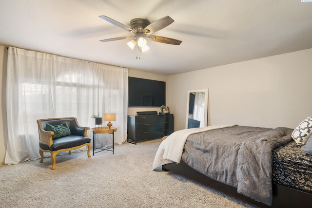 bedroom with light carpet and a ceiling fan