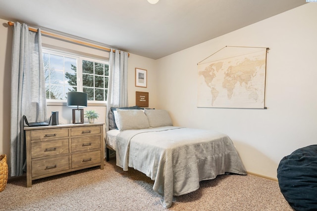 bedroom featuring baseboards and light colored carpet