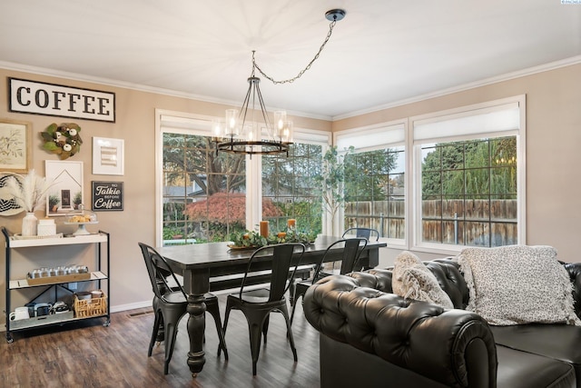 dining area featuring a chandelier, crown molding, and dark wood-style floors