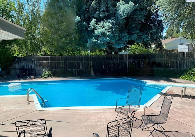 view of swimming pool with fence, a fenced in pool, and a patio