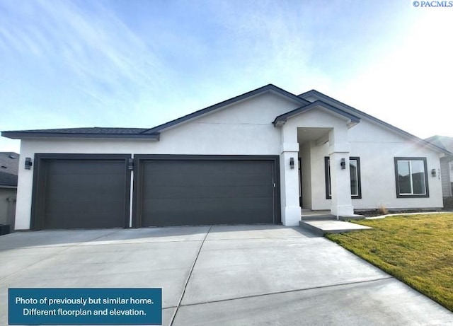 single story home featuring a garage and a front lawn