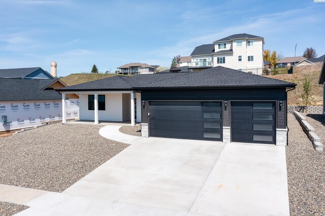 590 SW Cayuse St, Pullman, WA 99163 - prairie-style home with a garage, a shingled roof, concrete driveway, and a residential view