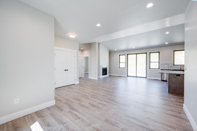 590 SW Cayuse St, Pullman, WA 99163 - unfurnished living room with recessed lighting, baseboards, light wood finished floors, and a fireplace