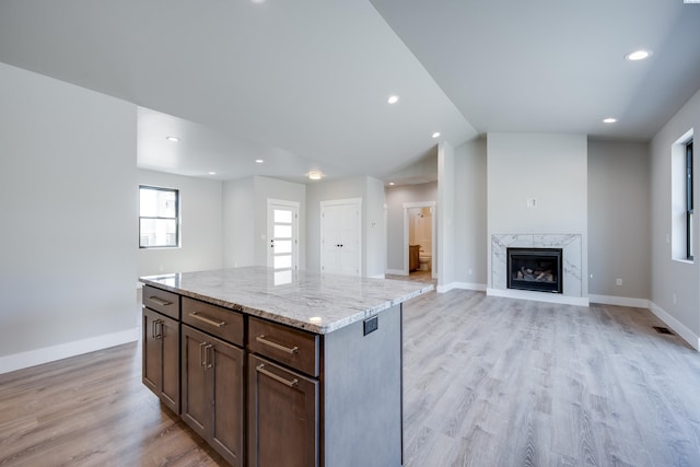 590 SW Cayuse St, Pullman, WA 99163 - kitchen featuring light wood-style floors, light stone counters, a center island, and recessed lighting