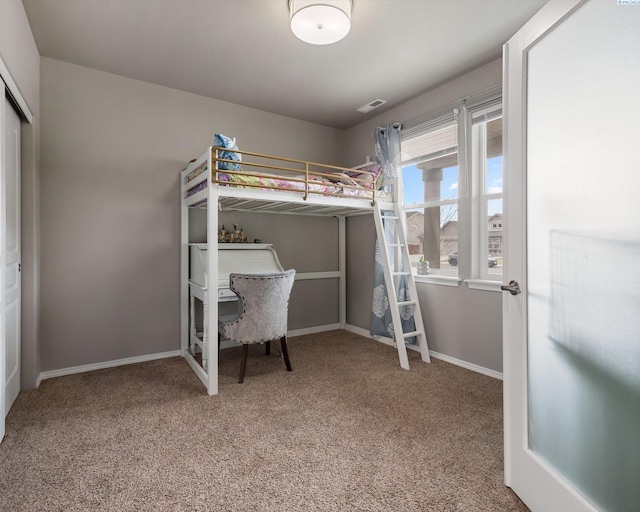 carpeted bedroom featuring visible vents and baseboards