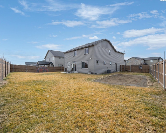 back of property featuring a fenced backyard, a patio, and a yard