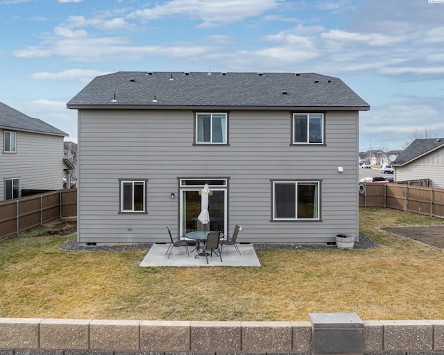 rear view of house with a patio area, a fenced backyard, roof with shingles, and a yard