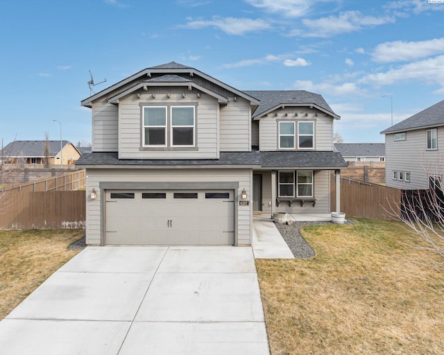 view of front of property with concrete driveway, a front lawn, an attached garage, and fence